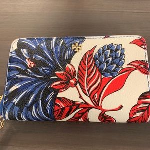 White and multicolor faux leather Tory wristlet.